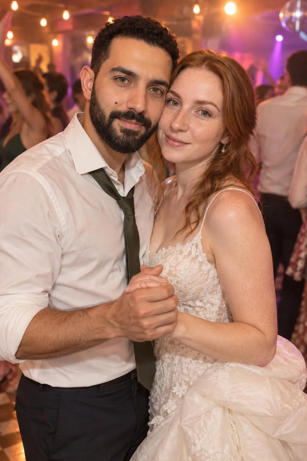 Wedding photo idea: a wedding couple laughing on a crowded dance floor